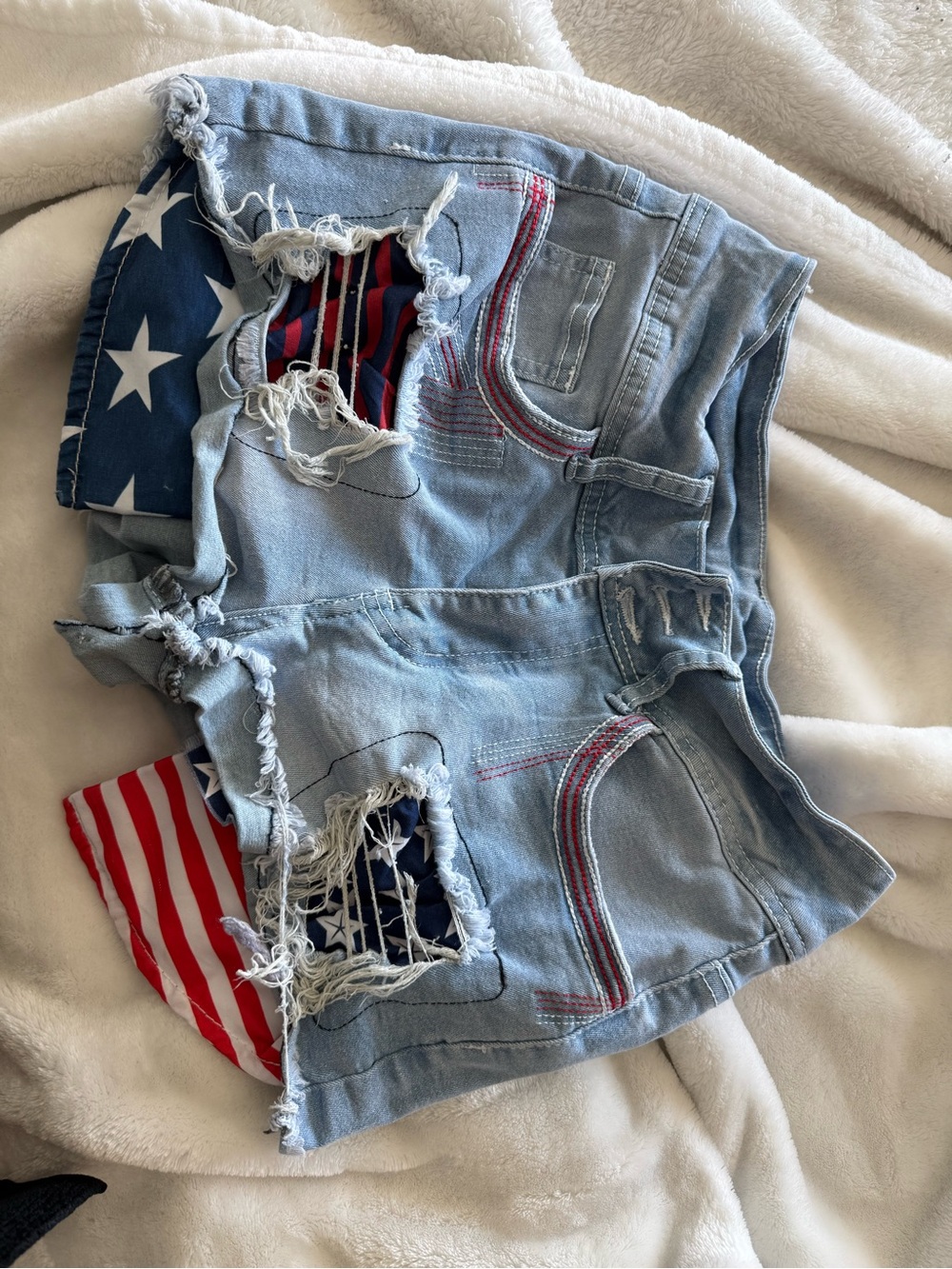 Frayed Light Blue Denim Women’s Shorts with Patriotic Patch Detail